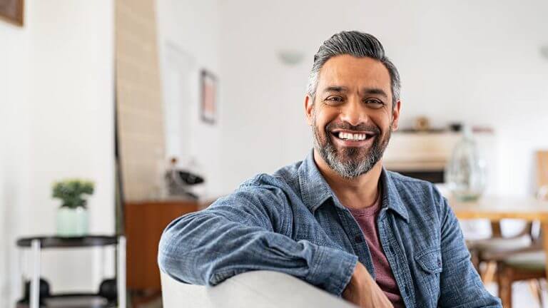 Portrait,Of,Handsome,Mature,Man,Relaxing,On,Couch,At,Home